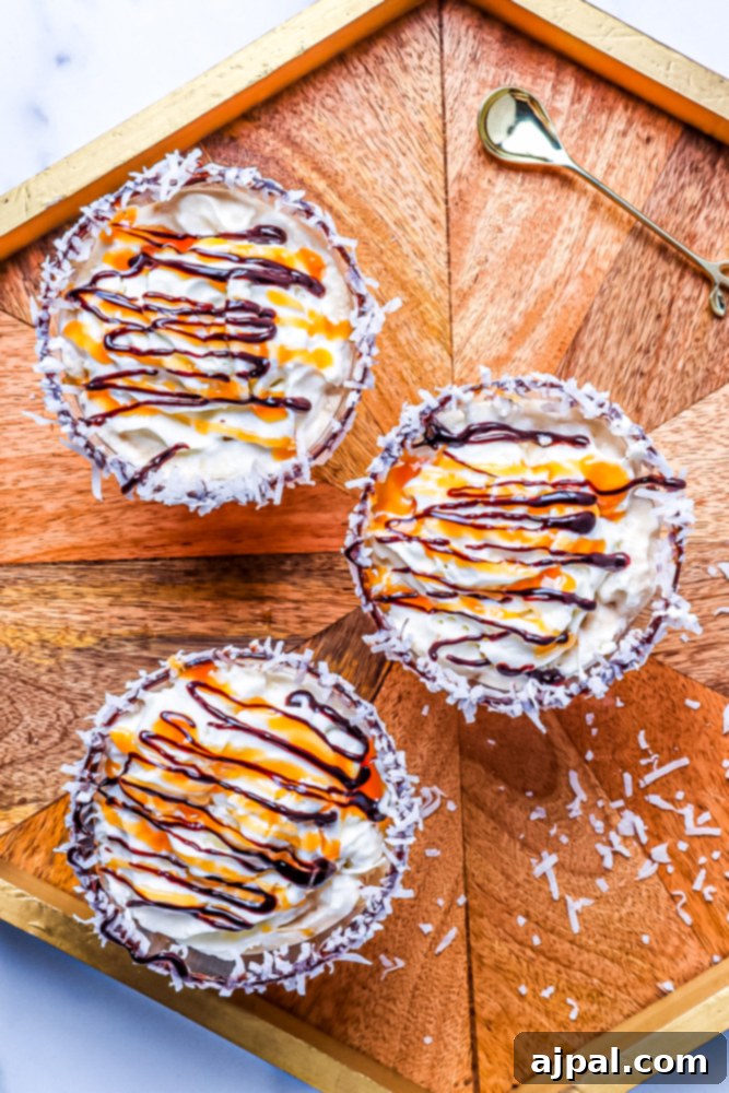 Samoa Martini Made Simple 6 A wooden tray featuring three luscious desserts, including a Samoa Martini and a chocolate caramel coconut martini, highlighting their decadent appeal.