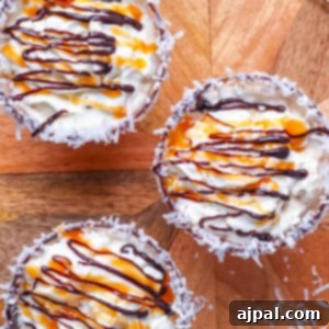 Three Samoa Martini coconut ice cream cups on a wooden tray.