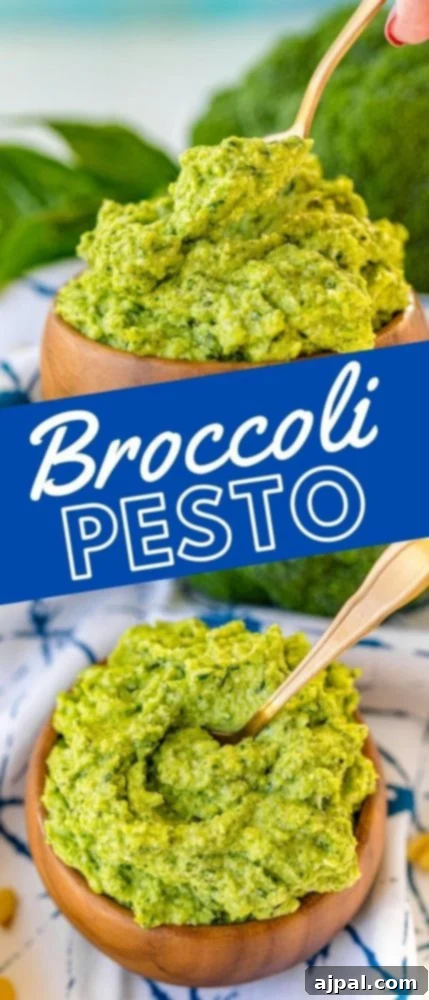 A picture of vibrant green broccoli pesto in a rustic wood bowl, accompanied by a spoon, with a second bowl blurred in the background, highlighting the fresh, homemade quality of this easy recipe.