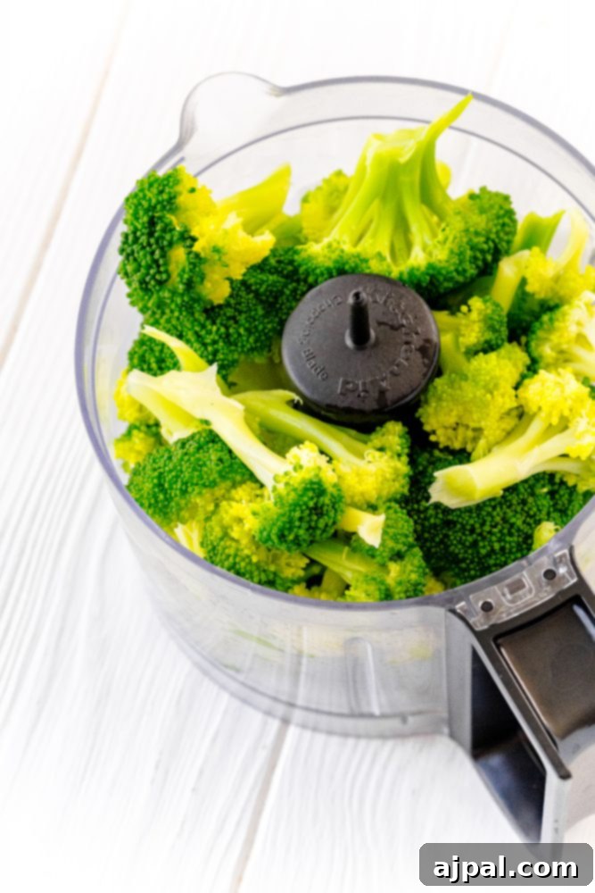 Easy and Delicious Broccoli Pesto 5 A food processor filled with broccoli, ready for processing.
