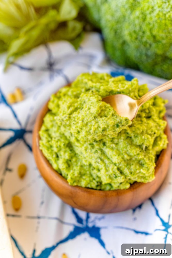 Easy and Delicious Broccoli Pesto 8 Broccoli pesto recipe in a wooden bowl with a spoon, ready to be served.