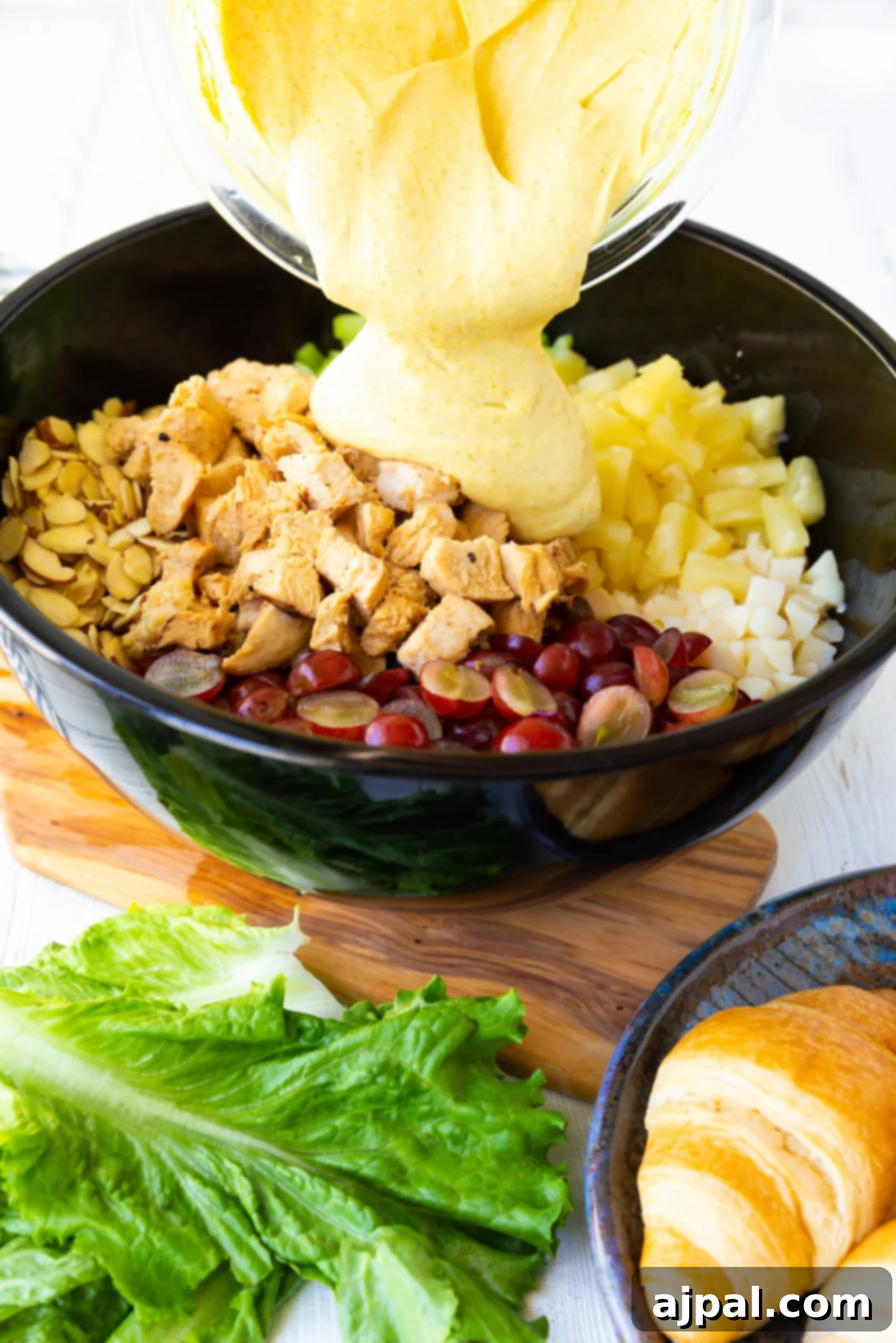 picture of dressing poured into chicken salad