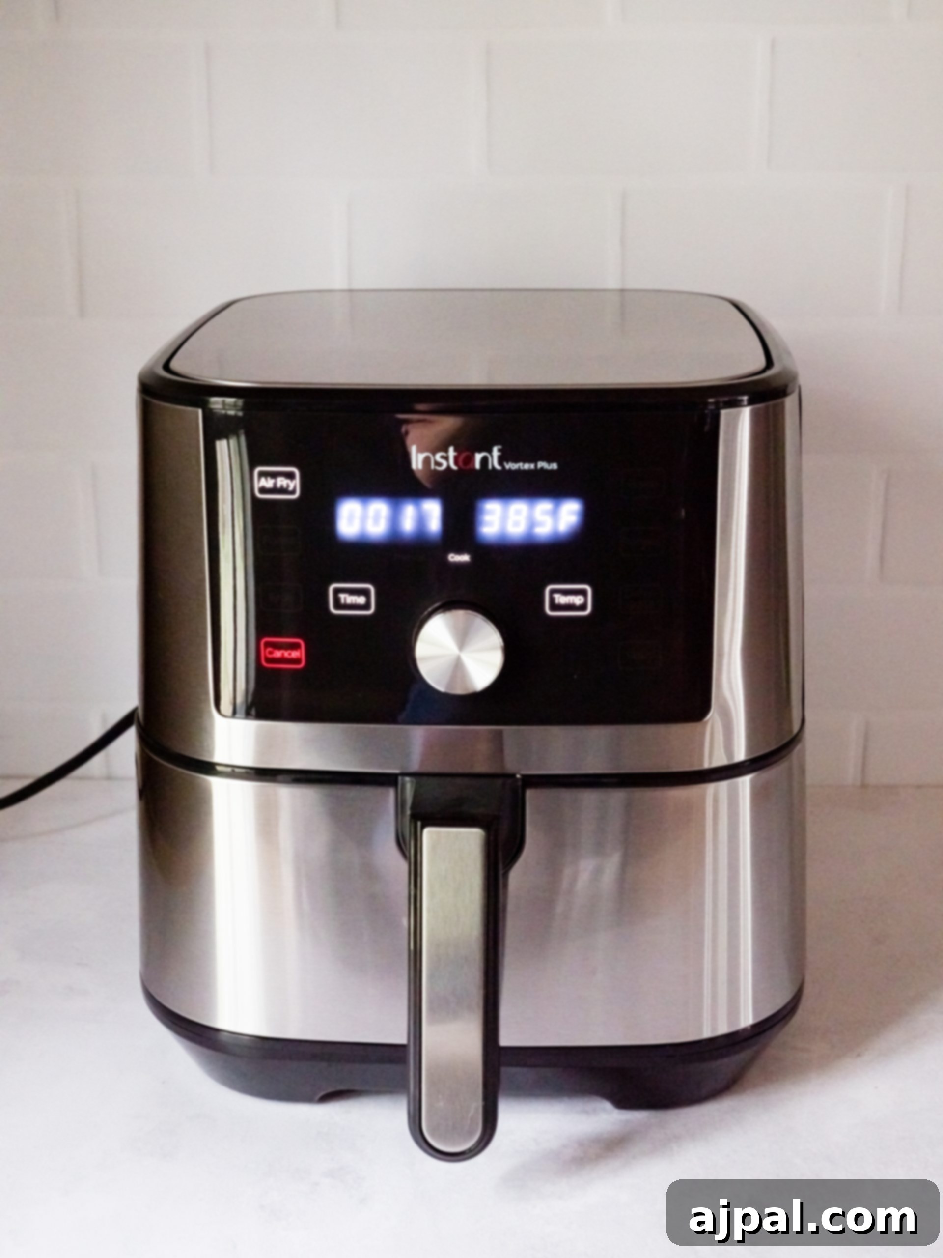 Air fryer in action, cooking French fries to a crisp.