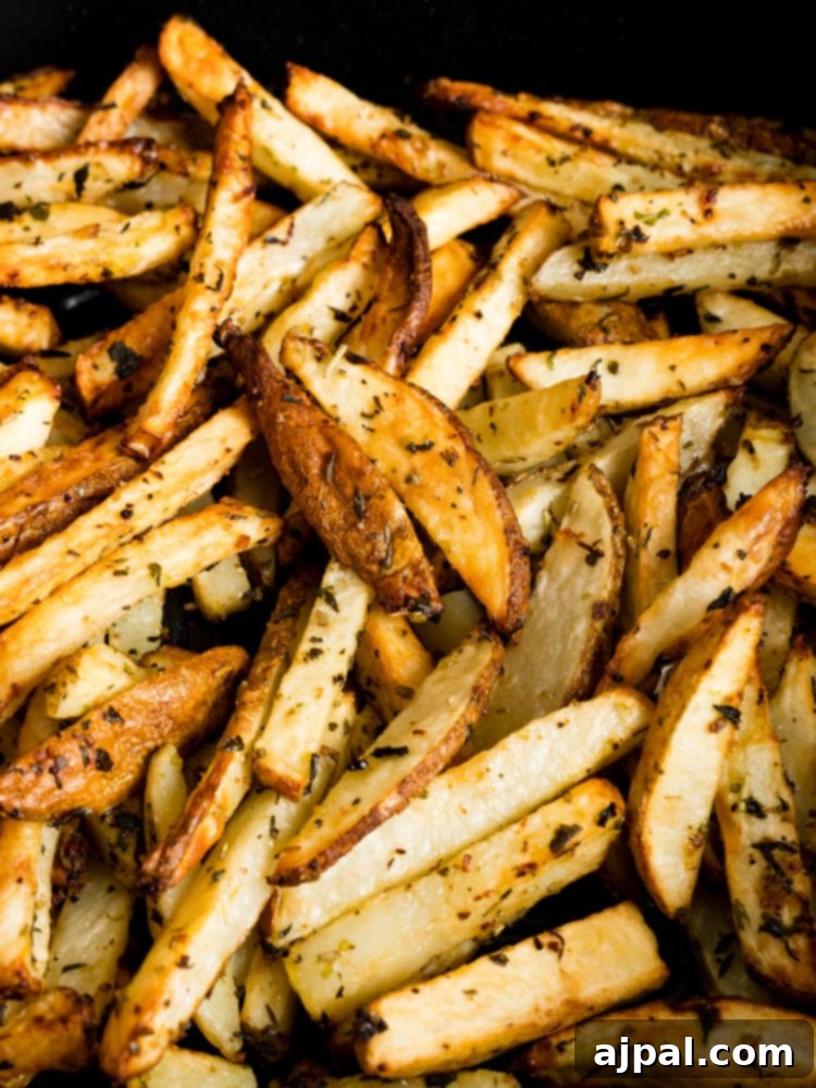 A basket full of golden, crispy lemon garlic French fries, freshly air-fried.