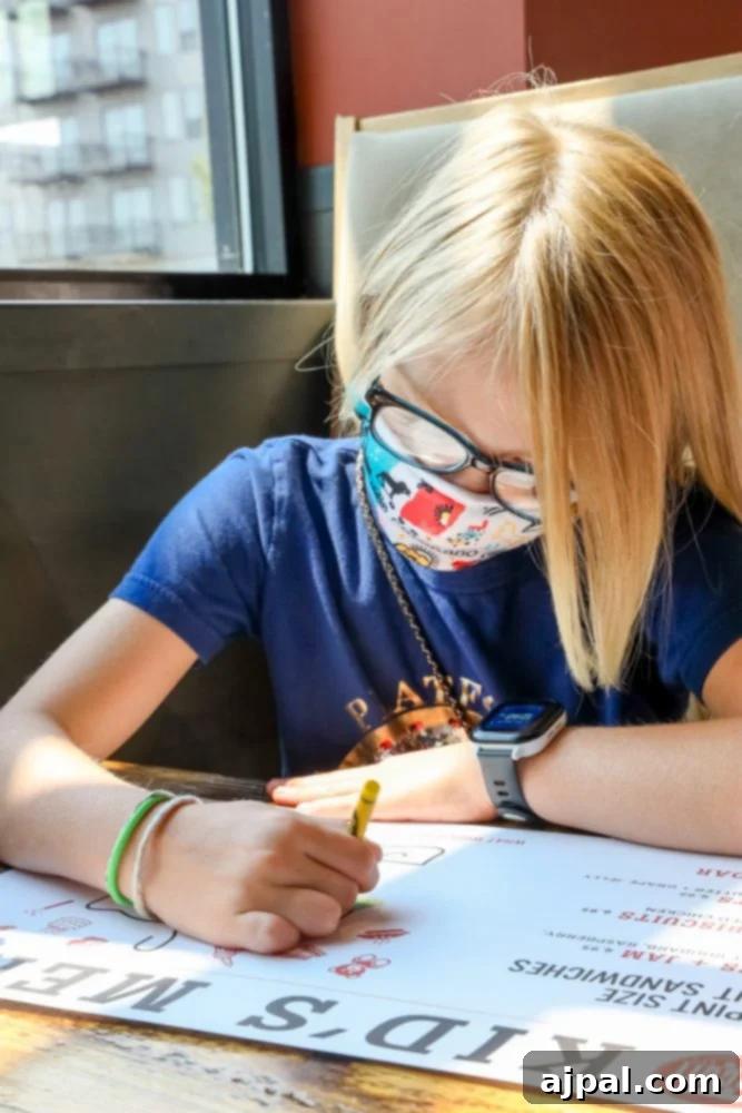 A young girl wearing a face mask, engaged in an activity during a family road trip in Southern Colorado.