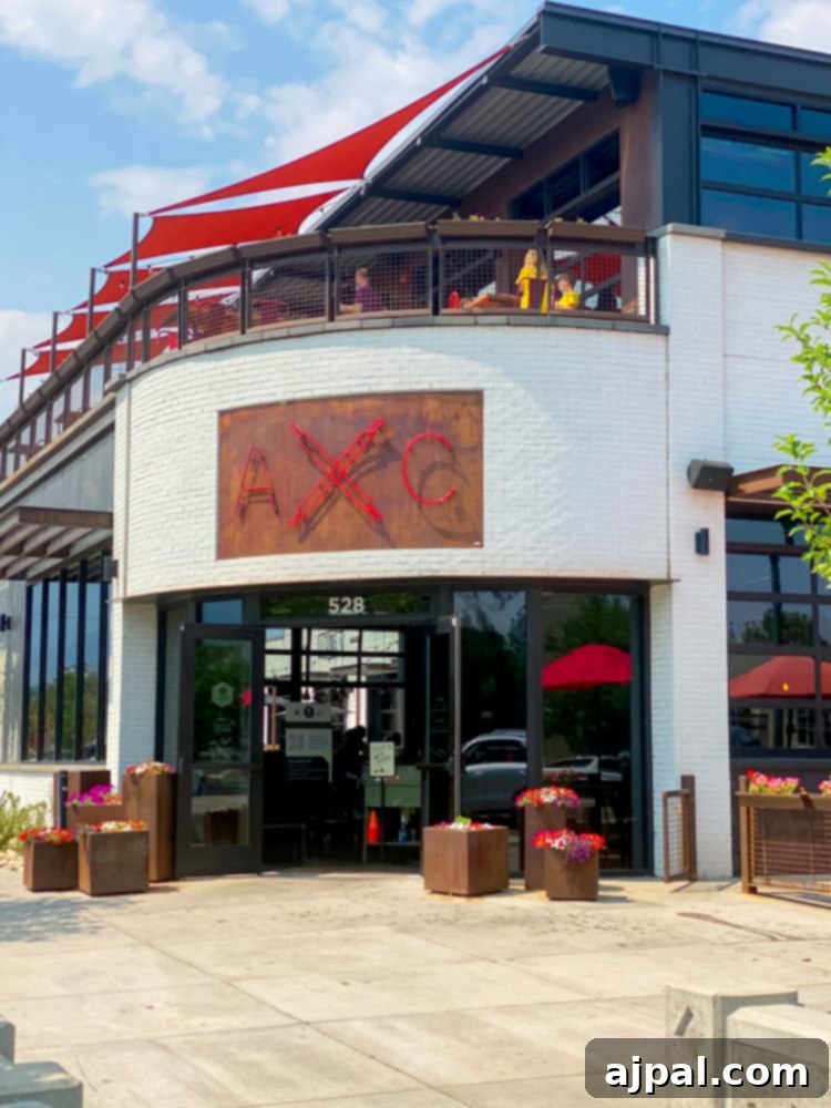 The Atomic Cowboy Complex in Colorado Springs, featuring outdoor seating with a distinctive red umbrella.