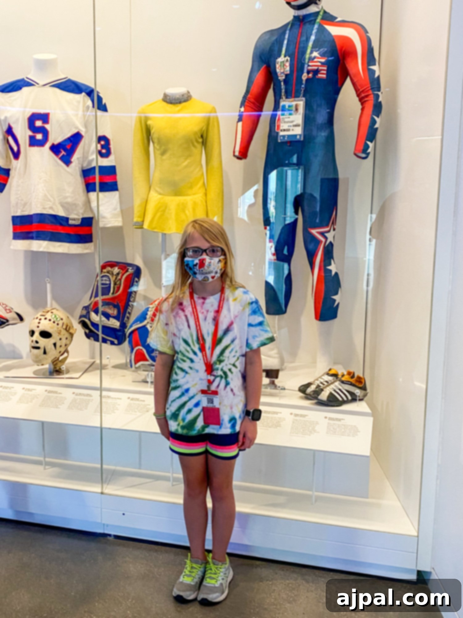 A young girl delighting in the Olympic uniforms and memorabilia at the US Olympic & Paralympic Museum.