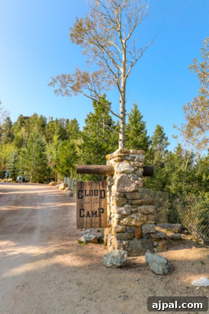 A sign marking the entrance to a scenic dirt road leading to The Broadmoor Cloud Camp.