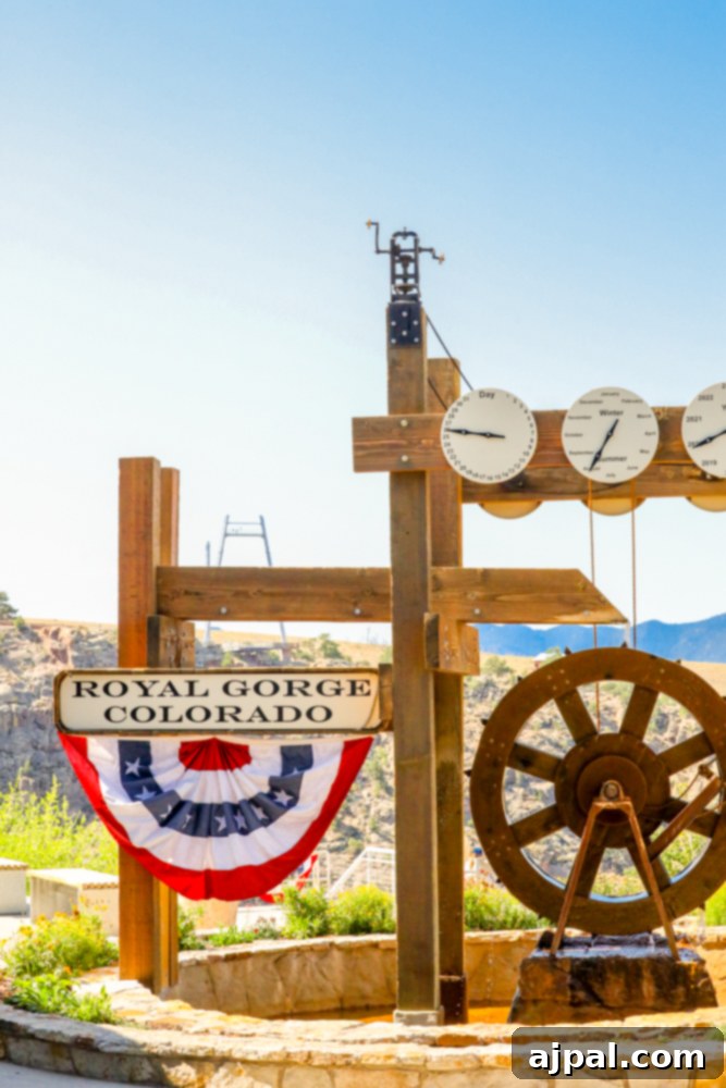 A charming wooden sign with a clock, marking the entrance to the Royal Gorge Bridge & Park.