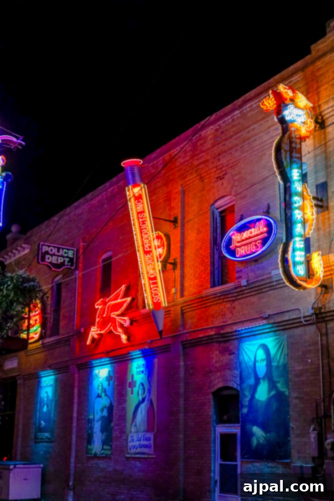 Vibrant neon signs illuminating Pueblo's Neon Alley at night.