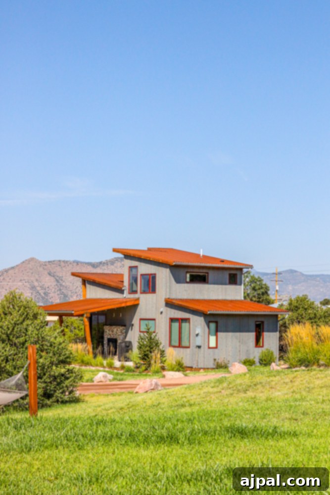 A charming cabin at Echo Canyon Campground, surrounded by a lush grassy field.