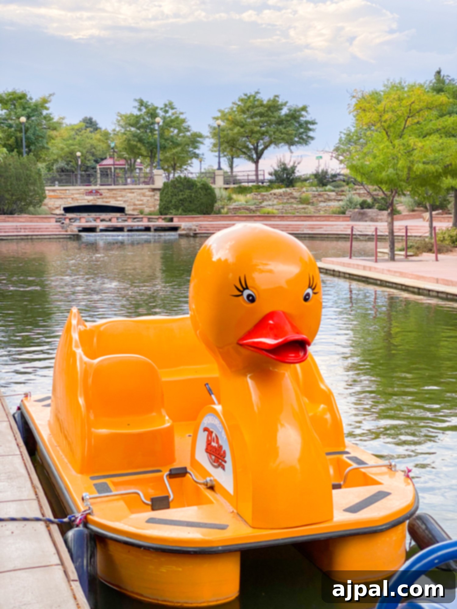 A playful paddle boat shaped like a duck on the Pueblo Riverwalk, inviting fun on the water.