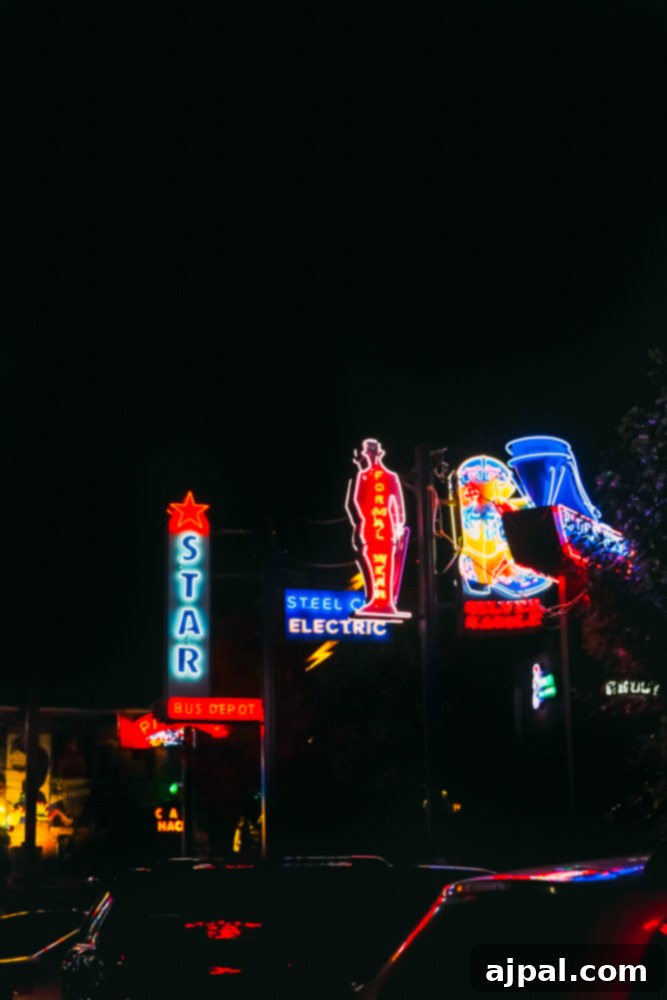 A vibrant and colorful collection of neon signs illuminating Neon Alley in Pueblo, Colorado.