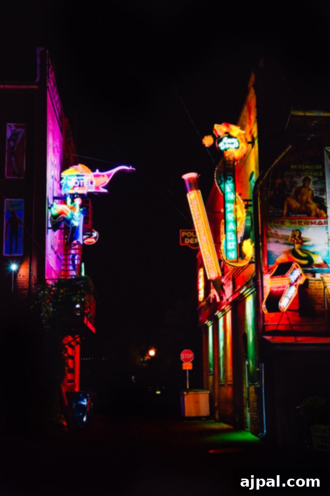 A dazzling array of neon lights illuminating a street in Pueblo, Colorado, creating a vibrant night scene.