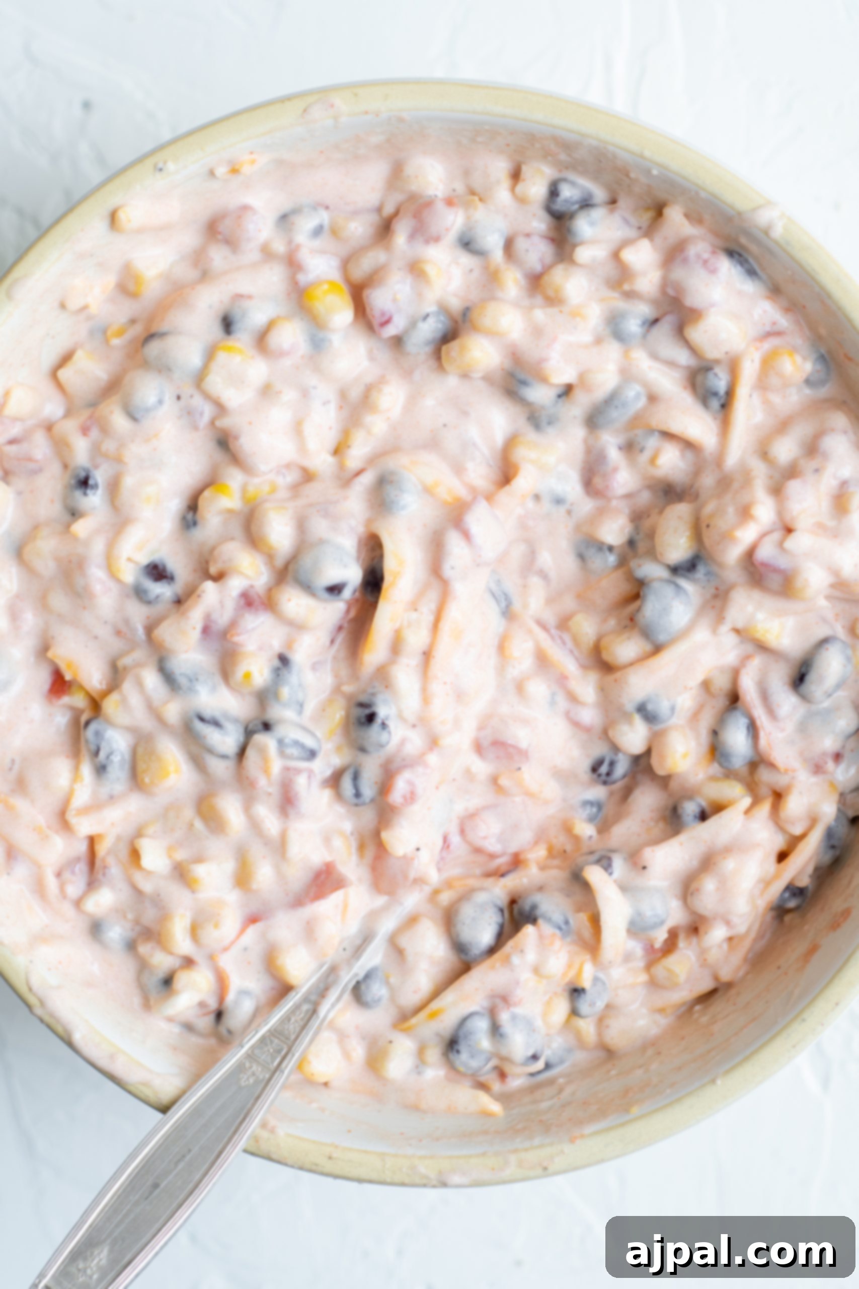 Crunchy Doritos Chicken Casserole 11 A bowl of Easy doritos chicken casserole with a spoon.
