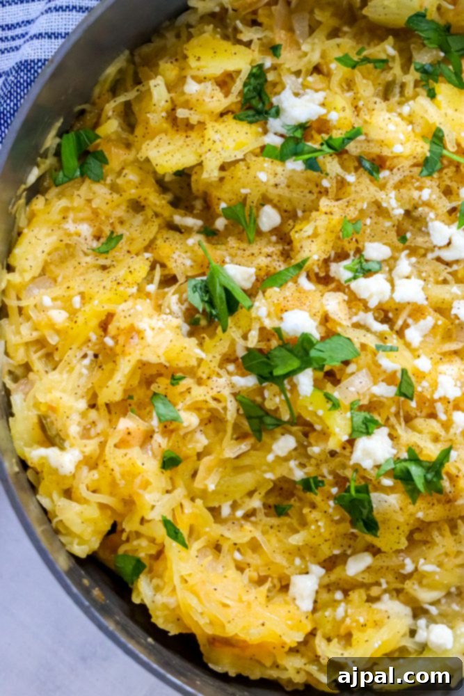 Delicious green chile spaghetti squash skillet with melted cheese and fresh herbs, ready to serve
