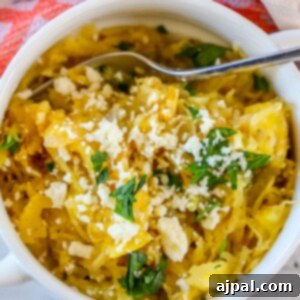 A bowl of roasted green chile spaghetti squash with feta cheese and parsley.