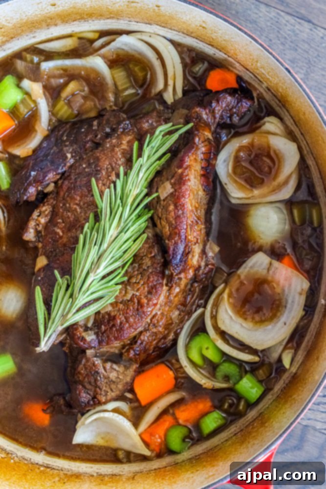 Fall-Apart Tender Pot Roast 7 A keto-friendly pot roast recipe with tender meat and vegetables cooked in a pot.