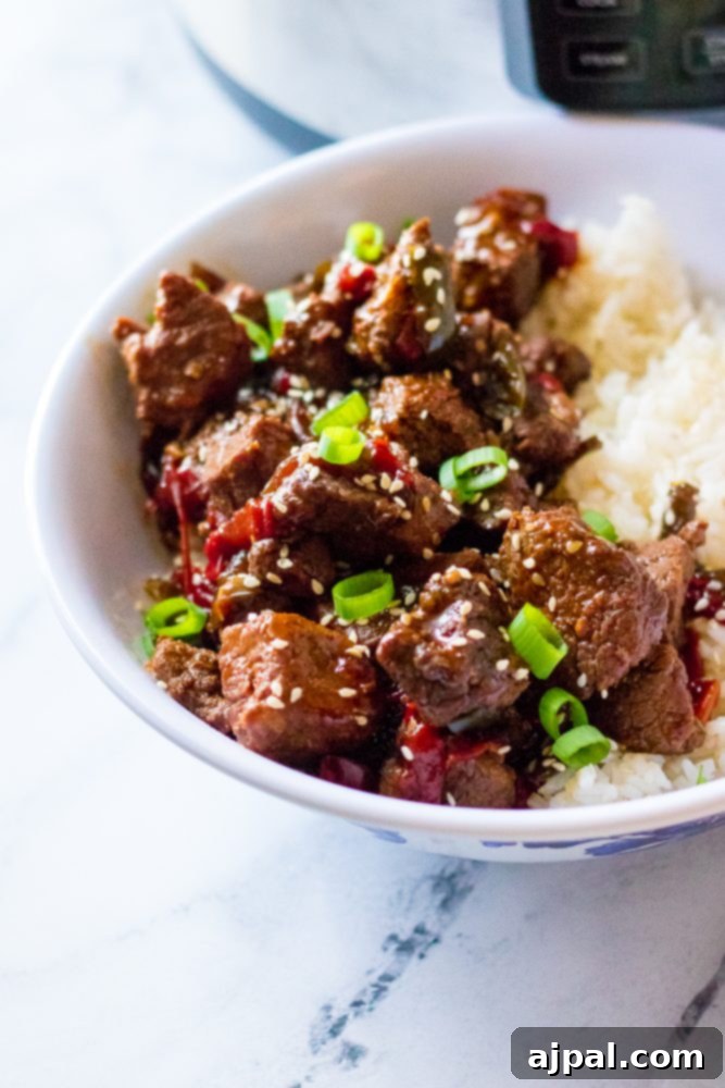 Quick & Flavorful Instant Pot Korean Beef 2 picture of korean beef in a bowl with scallions and rice, garnished with sesame seeds