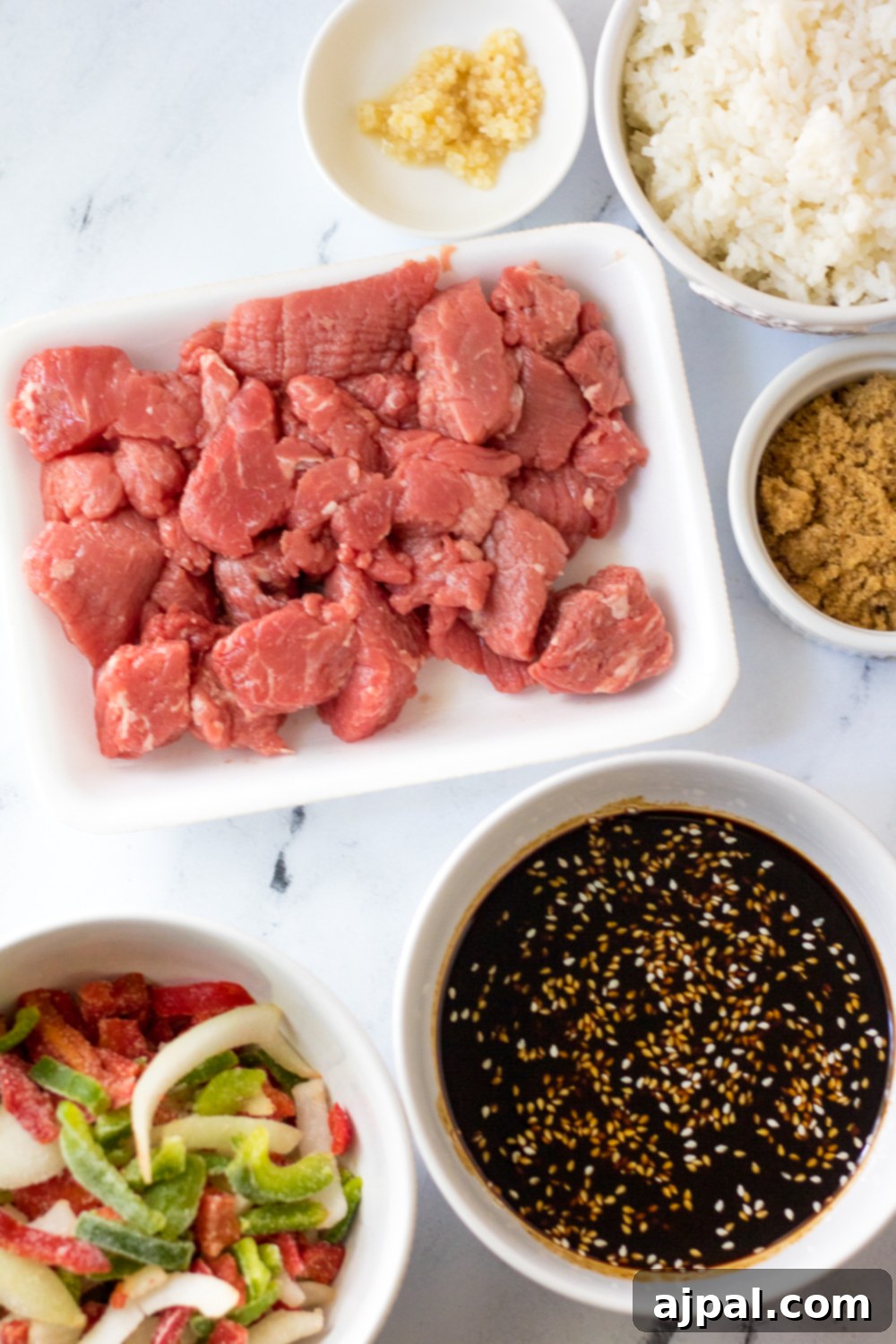 Quick & Flavorful Instant Pot Korean Beef 4 easy korean beef stir fry ingredients on a white marble table.