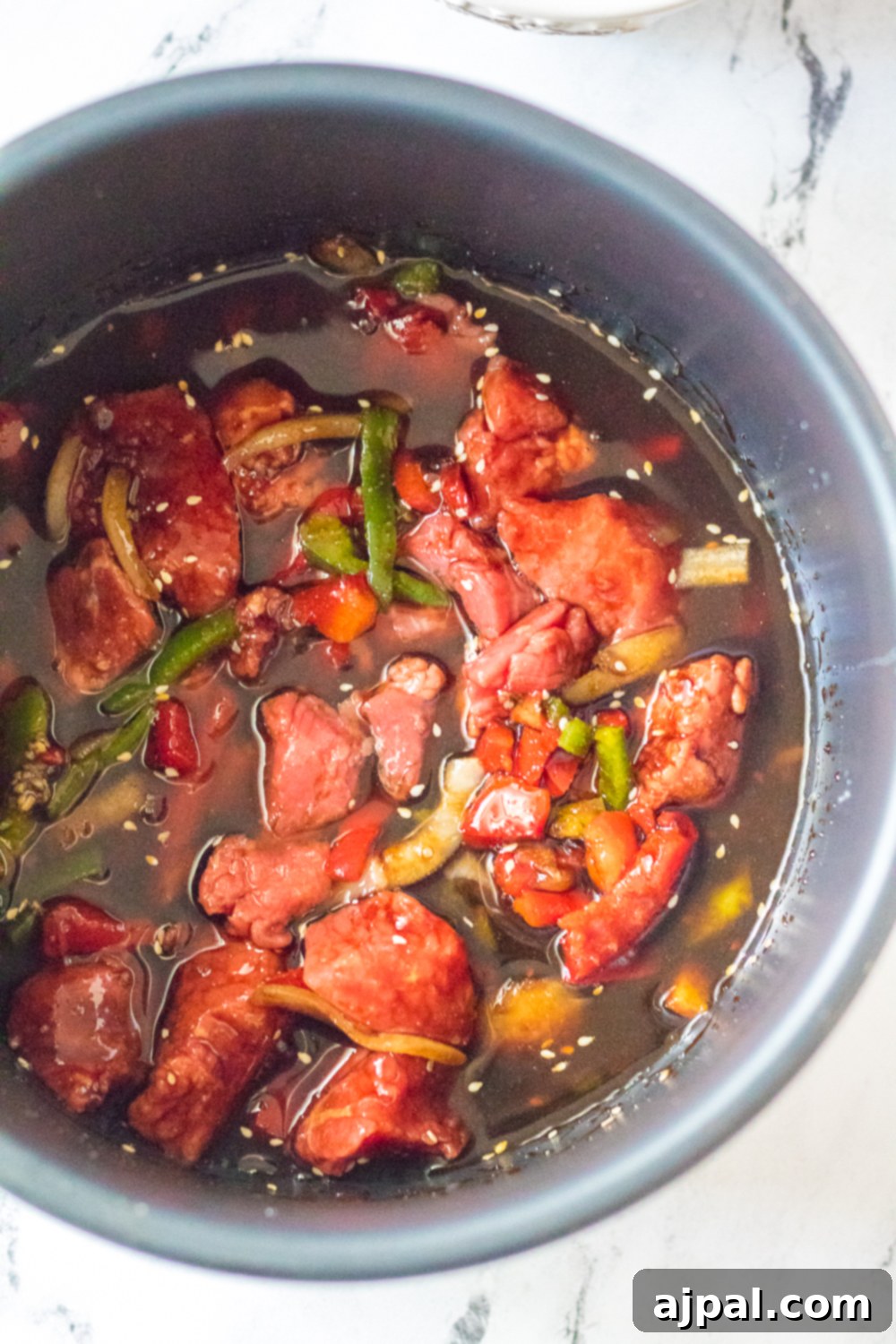 Quick & Flavorful Instant Pot Korean Beef 5 An easy Instant Pot Korean beef recipe with meat and vegetables cooked together in a bowl.