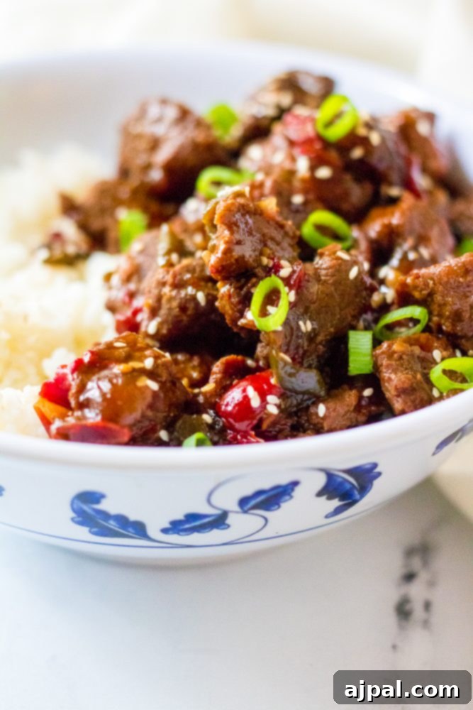 Quick & Flavorful Instant Pot Korean Beef 7 picture of korean beef in a bowl with scallions and rice