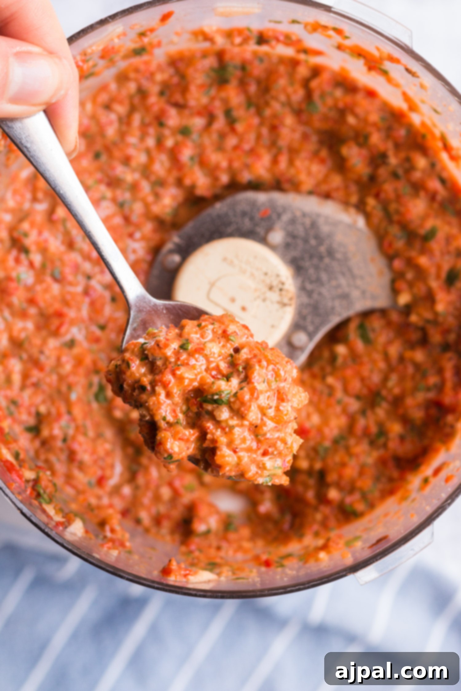 Effortless Cauliflower Steaks with Tangy Red Pepper Sauce 8 A spoonful of rich red pepper sauce being drizzled over perfectly grilled cauliflower steaks.