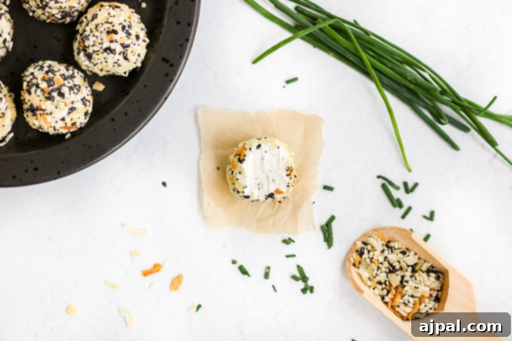 Savory Keto Everything Bagel Fat Bomb 11 picture of fat bombs in everything bagel seasoning on a plate with chives
