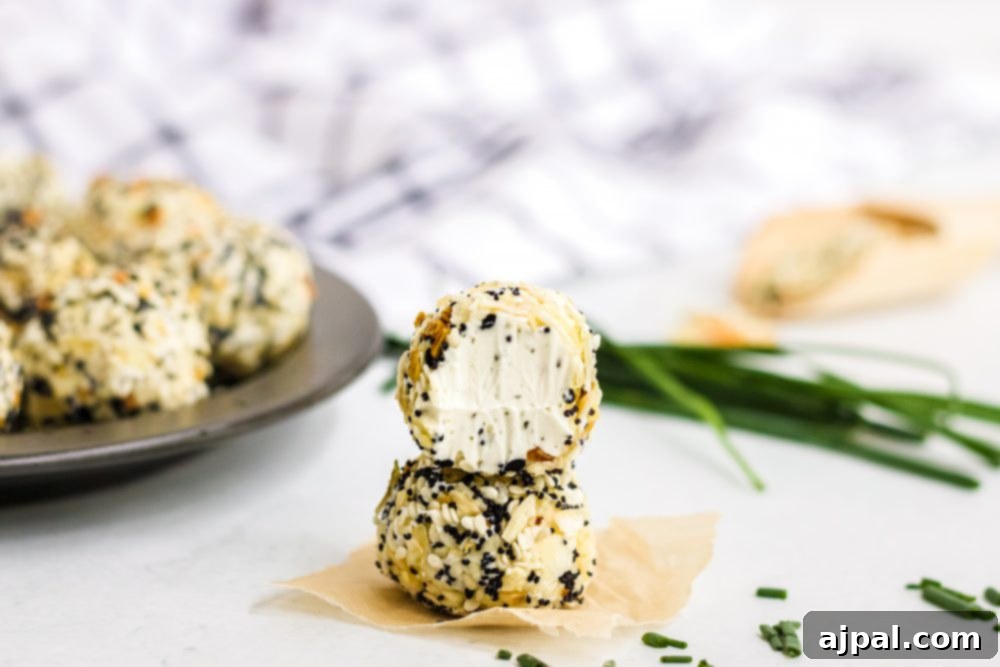 Savory Keto Everything Bagel Fat Bomb 13 picture of fat bombs in everything bagel seasoning on a plate with chives