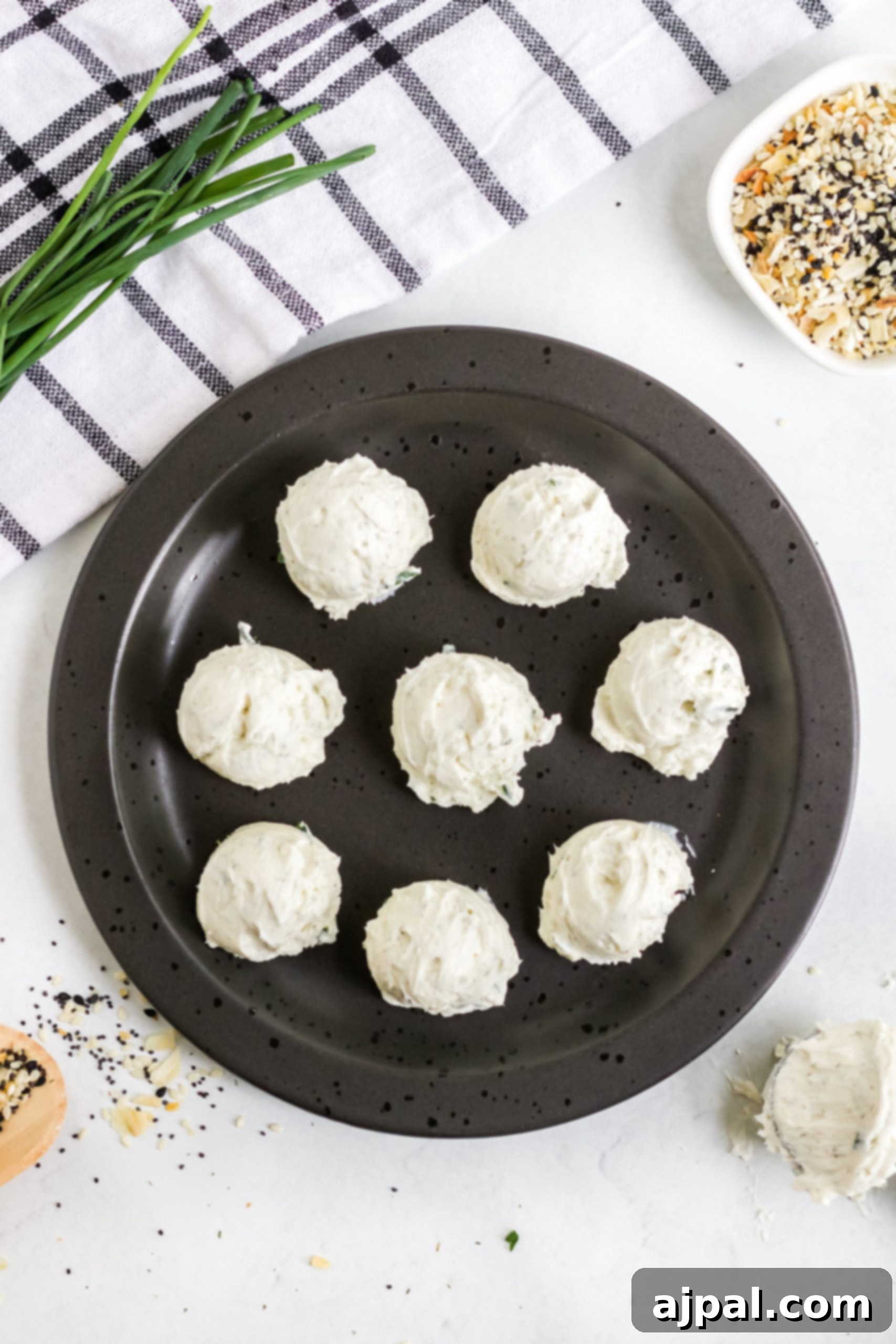 Savory Keto Everything Bagel Fat Bomb 7 A plate with a variety of keto fat bombs, including everything bagel and everything-flavored options.