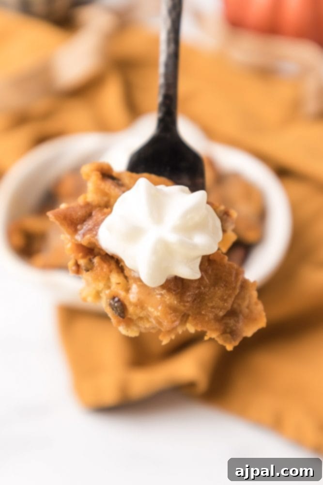 Slow Cooker Pumpkin Bread Pudding: A Cozy Autumn Dessert 2 A delicious spoonful of slow cooker pumpkin bread pudding with a dollop of whipped cream on top, ready to be enjoyed.