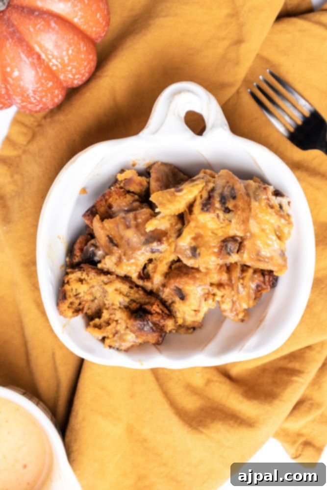 Slow Cooker Pumpkin Bread Pudding: A Cozy Autumn Dessert 3 A serving of pumpkin bread pudding with a fork, garnished with whipped cream, in a rustic setting.