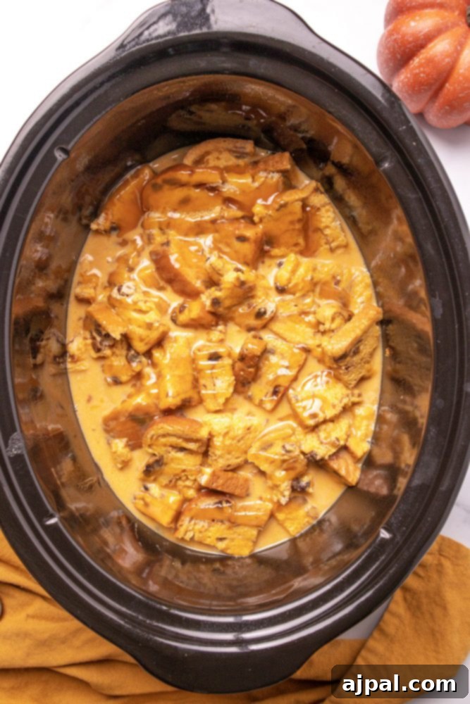 Slow Cooker Pumpkin Bread Pudding: A Cozy Autumn Dessert 6 The uncooked pumpkin bread pudding mixture nestled within a slow cooker, ready for the gentle heat to transform it.
