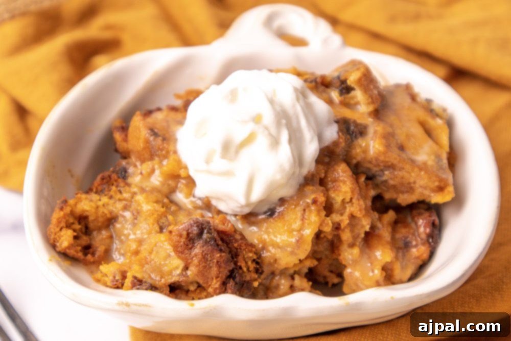 Slow Cooker Pumpkin Bread Pudding: A Cozy Autumn Dessert 9 A beautiful presentation of pumpkin bread pudding with whipped cream in a white bowl, ready to be served.