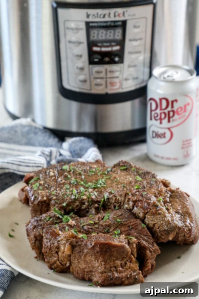 Fork-Tender Dr Pepper Instant Pot Pot Roast 2 A perfectly cooked Dr Pepper pot roast, served alongside a can of Dr Pepper and an Instant Pot, highlighting its tender texture.