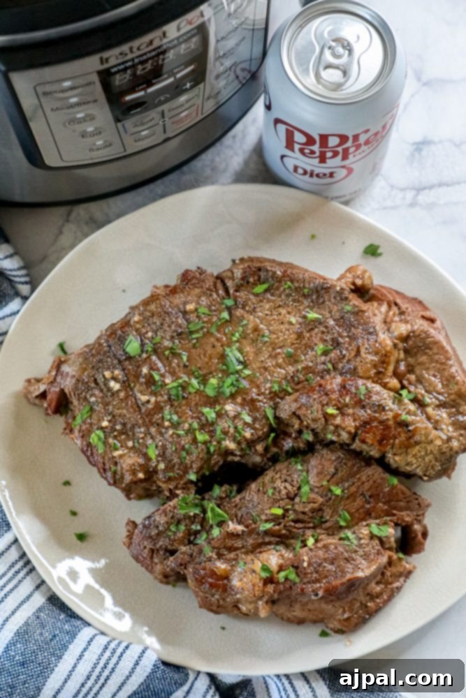 Fork-Tender Dr Pepper Instant Pot Pot Roast 4 A large, juicy piece of Dr Pepper pot roast, fresh from the Instant Pot, ready to be shredded and served.