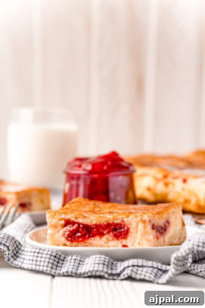 Baked cherry cheesecake danish on a white plate