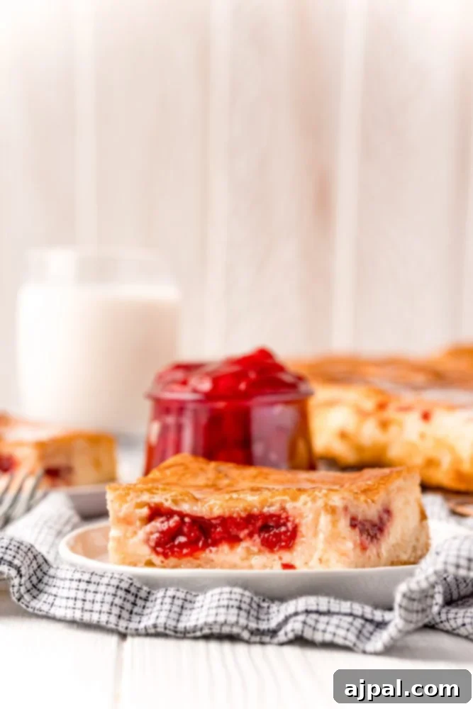 baked cherry cheesecake danish on a white plate