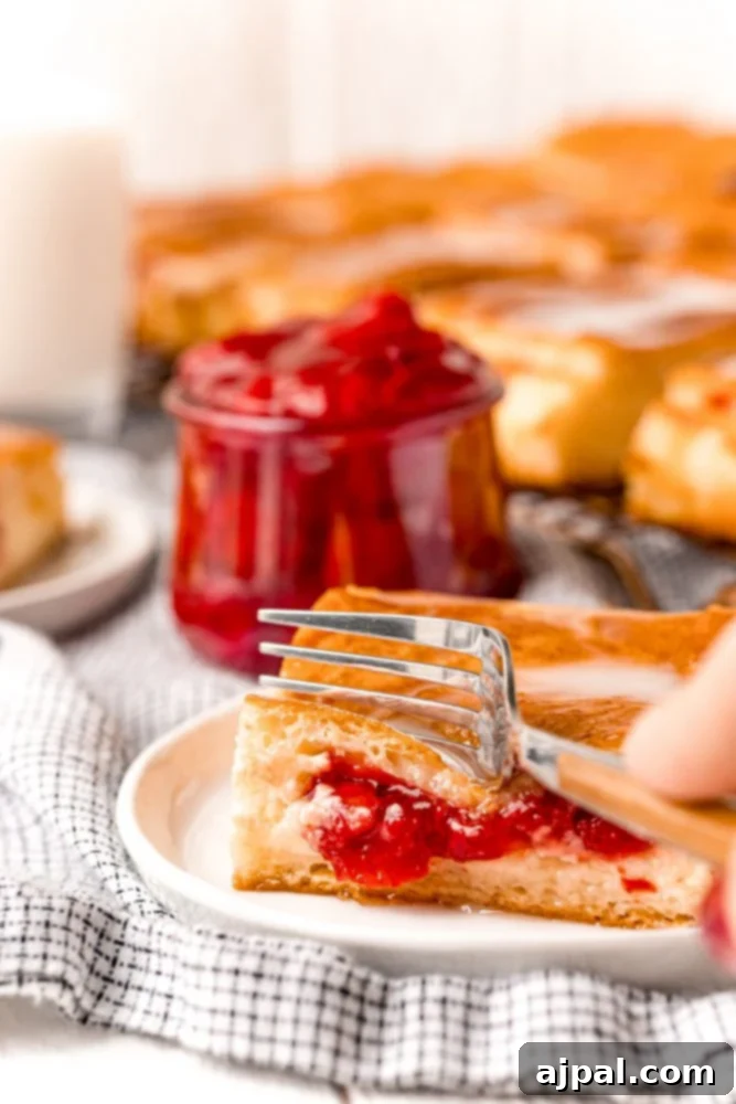 slice of cherry cheesecake danish on a plate on a table