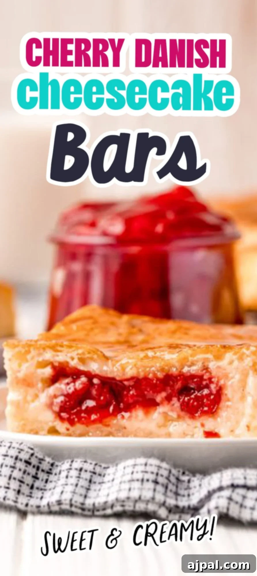 baked cherry cheesecake danish on a white plate
