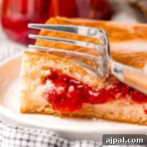 baked cherry cheesecake danish on a white plate