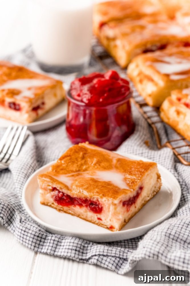Baked cherry cheesecake danish on a white plate
