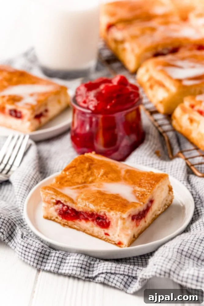 baked cherry cheesecake danish on a white plate