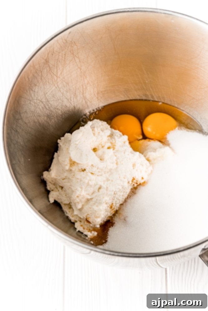 Sugar, eggs, cream cheese in a bowl for mixing