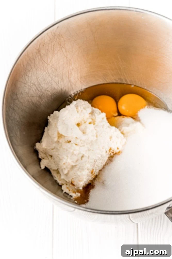 sugar, eggs, cream cheese in a bowl 