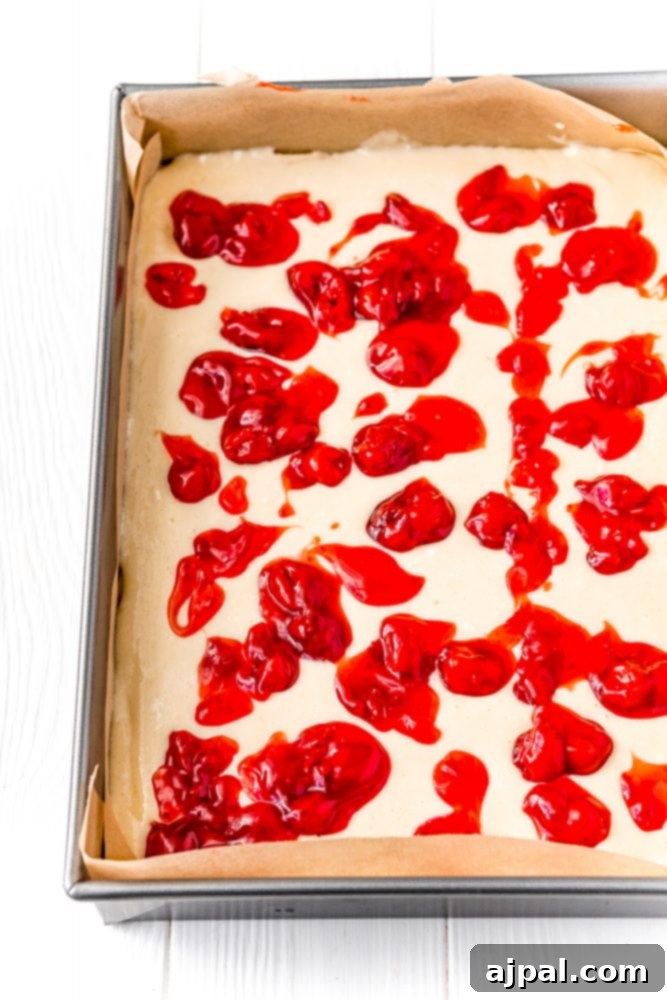 Cream cheese and cherry mixture in a baking pan