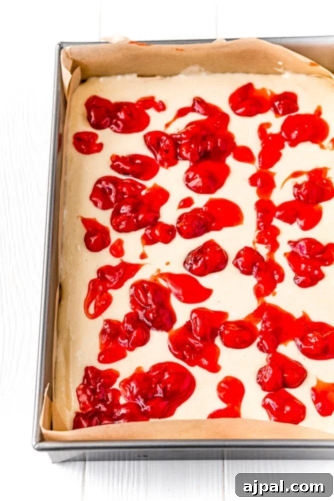 cream cheese and cherry mixture in a pan