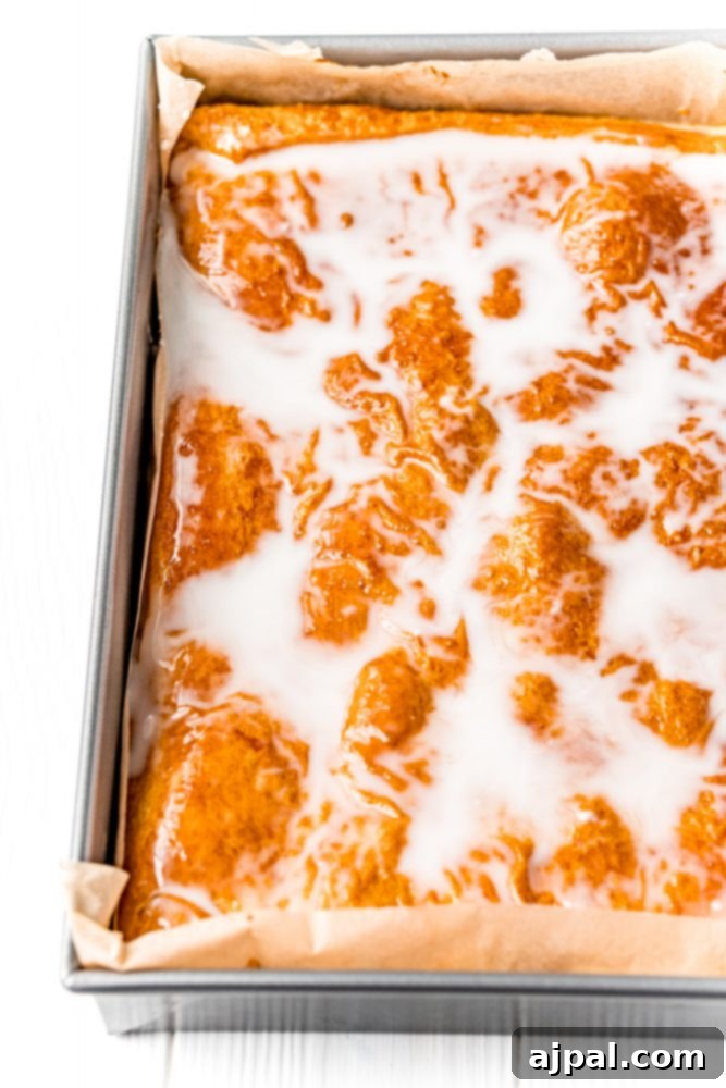 Baked glazed pastry over cheesecake in a pan