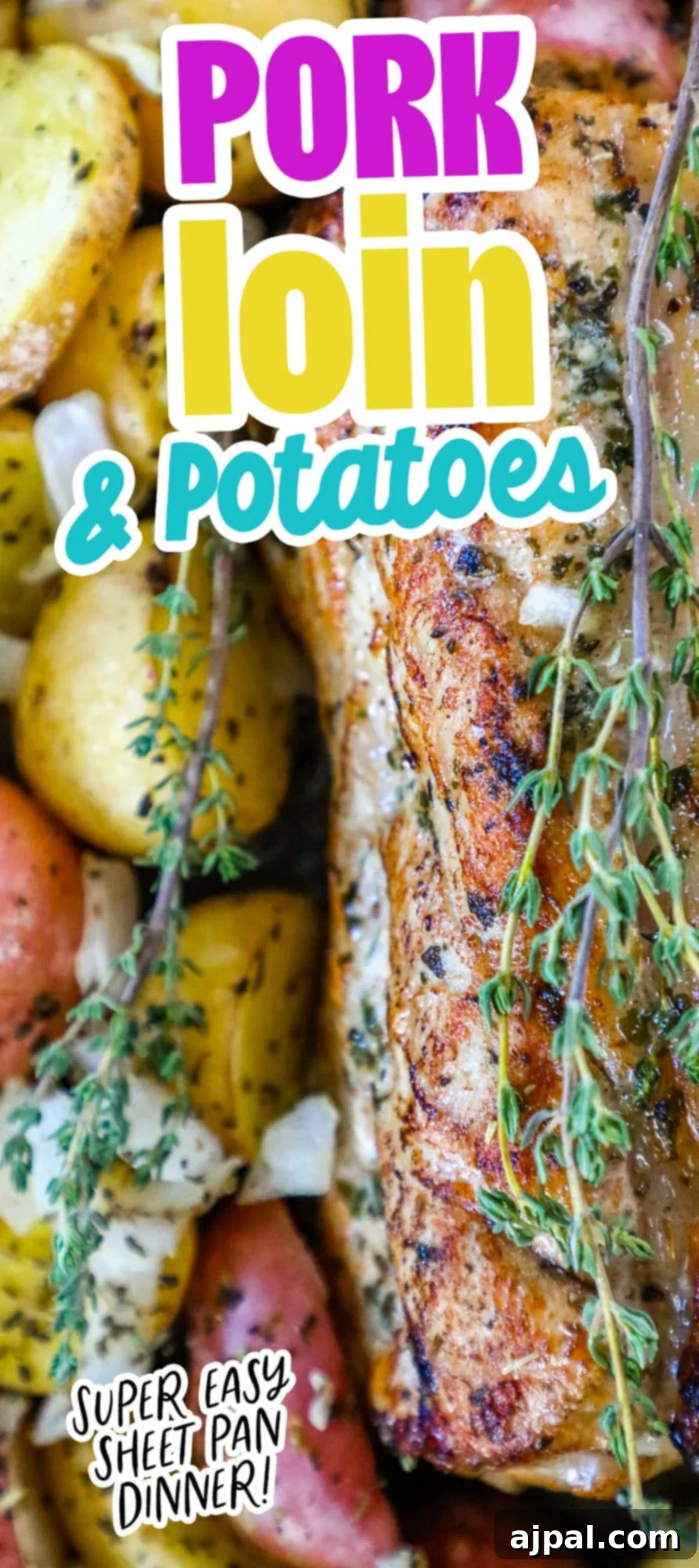 Large, appetizing image of garlic herb butter baked pork loin and potatoes on a sheet pan.