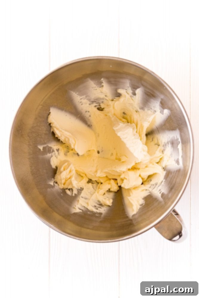 Softened cream cheese and butter, perfectly creamed together in the bowl of a stand mixer, forming a smooth, light base for the buttercream.